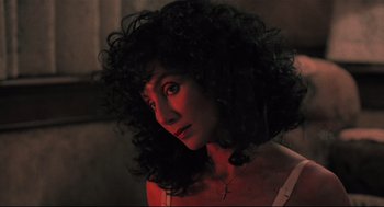 Movie still from “Moonstruck” (1987), directed by Norman Jewison – A person wearing a necklace; Close Up shot, Low angle