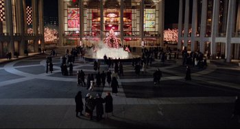 Movie still from “Moonstruck” (1987), directed by Norman Jewison – A group of people standing in front of a fountain at night; Extreme Wide shot, High angle