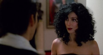 Movie still from “Moonstruck” (1987), directed by Norman Jewison – A woman in a black dress is looking at a man in a black suit; Close Up shot, Over the shoulder angle