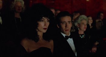 Movie still from “Moonstruck” (1987), directed by Norman Jewison – A man and a woman in a black suit and tie; Close Up shot, Over the shoulder angle