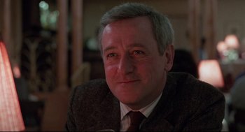 Movie still from “Moonstruck” (1987), directed by Norman Jewison – A person wearing a suit and tie; Close Up shot, Low angle