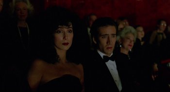 Movie still from “Moonstruck” (1987), directed by Norman Jewison – A man and a woman in a black dress; Medium shot, High angle
