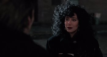 Movie still from “Moonstruck” (1987), directed by Norman Jewison – A woman in a black coat and a black wig; Close Up shot, Over the shoulder angle