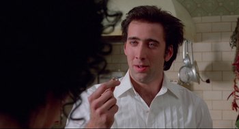 Movie still from “Moonstruck” (1987), directed by Norman Jewison – A man in a white dress shirt is looking in the mirror; Close Up shot, Over the shoulder angle