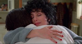 Movie still from “Moonstruck” (1987), directed by Norman Jewison – Two women embracing each other on a bed; Close Up shot, High angle