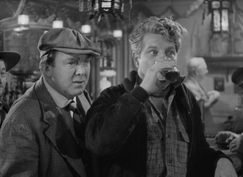 Movie still from “Moontide” (1942), directed by Fritz Lang – Two men are drinking a beer in a bar; Medium shot, Over the shoulder angle