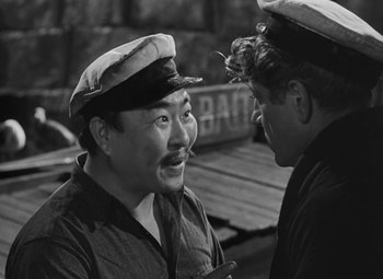 Movie still from “Moontide” (1942), directed by Fritz Lang – Two men talking to each other while standing next to each other; Close Up shot, Over the shoulder angle