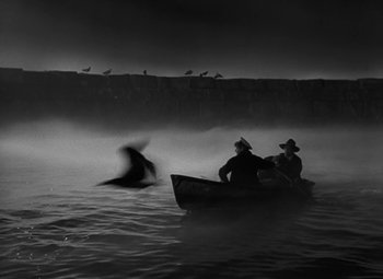 Movie still from “Moontide” (1942), directed by Fritz Lang – Two people in a boat in the middle of the night; Wide shot, High angle