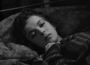 Movie still from “Moontide” (1942), directed by Fritz Lang – A woman laying in bed with her head resting on a pillow; Close Up shot, High angle