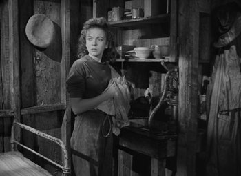 Movie still from “Moontide” (1942), directed by Fritz Lang – A black and white photo of a woman holding a towel; Medium shot, Low angle