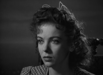 Movie still from “Moontide” (1942), directed by Fritz Lang – A black - and - white photo of a woman in a checkered shirt; Close Up shot, Low angle