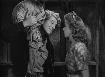 Movie still from “Moontide” (1942), directed by Fritz Lang – An old photo of a man and a girl; Medium shot, Low angle