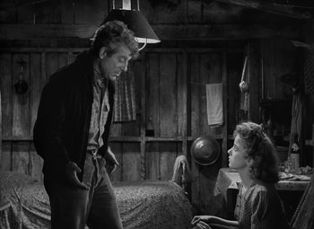 Movie still from “Moontide” (1942), directed by Fritz Lang – A man and a woman are talking in a room; Medium shot, Over the shoulder angle