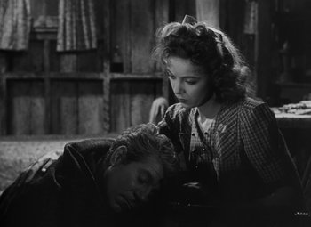 Movie still from “Moontide” (1942), directed by Fritz Lang – An old black and white photo of a man and a woman; Medium shot, Over the shoulder angle