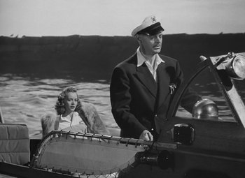 Movie still from “Moontide” (1942), directed by Fritz Lang – A man and a woman are in a boat in the water; Medium shot, High angle