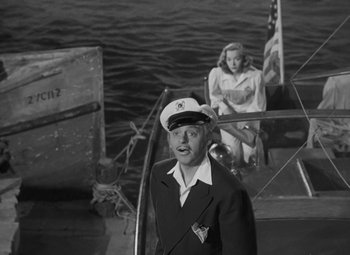 Movie still from “Moontide” (1942), directed by Fritz Lang – A man and a woman on a boat in the water; Medium shot, High angle