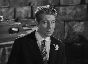 Movie still from “Moontide” (1942), directed by Fritz Lang – Black and white photograph of a man wearing a suit and tie; Close Up shot, High angle