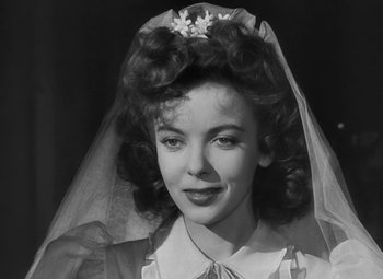 Movie still from “Moontide” (1942), directed by Fritz Lang – A black and white photo of a woman wearing a veil; Close Up shot, High angle