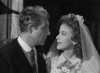 Movie still from “Moontide” (1942), directed by Fritz Lang – An older man and a young woman in wedding attire; Close Up shot, High angle