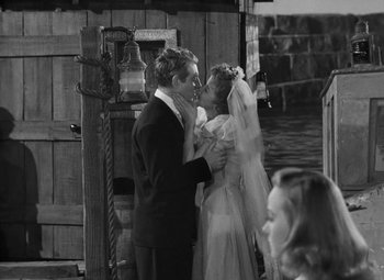 Movie still from “Moontide” (1942), directed by Fritz Lang – A black and white photo of a man and a woman; Medium shot, High angle