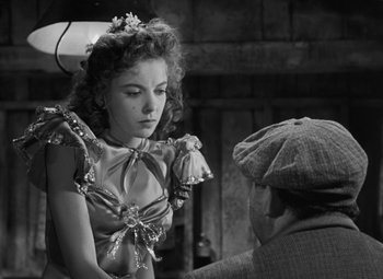 Movie still from “Moontide” (1942), directed by Fritz Lang – An old photo of a woman and a man talking; Medium shot, Over the shoulder angle