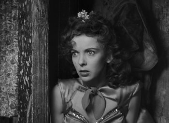 Movie still from “Moontide” (1942), directed by Fritz Lang – A black - and - white photo of a woman in a dress; Close Up shot, Low angle