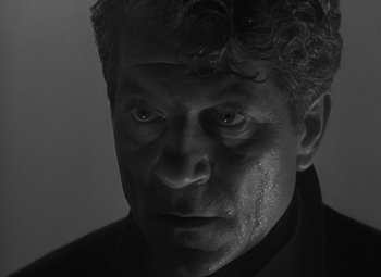 Movie still from “Moontide” (1942), directed by Fritz Lang – Black and white photograph of a man's face with tears coming out of his eyes; Close Up shot, Low angle