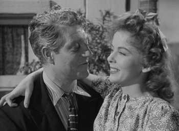 Movie still from “Moontide” (1942), directed by Fritz Lang – An older man and a young woman embracing each other; Medium shot, Over the shoulder angle