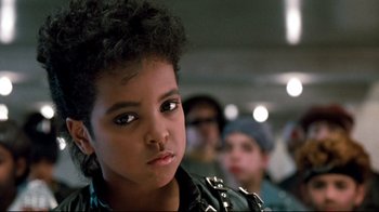 Movie still from “Moonwalker” (1988), directed by Jerry Kramer – A person wearing a leather jacket; Close Up shot, High angle