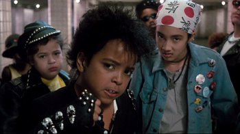 Movie still from “Moonwalker” (1988), directed by Jerry Kramer – A group of young people standing next to each other; Close Up shot, Low angle