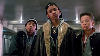 Movie still from “Moonwalker” (1988), directed by Jerry Kramer – A couple of men standing next to each other; Medium shot, Low angle