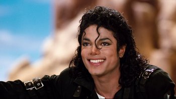 Movie still from “Moonwalker” (1988), directed by Jerry Kramer – A person with a smile on their face; Close Up shot, High angle