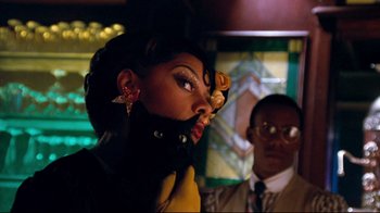 Movie still from “Moonwalker” (1988), directed by Jerry Kramer – A man and a woman are standing next to each other; Close Up shot, Low angle