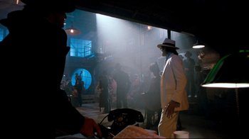 Movie still from “Moonwalker” (1988), directed by Jerry Kramer – A man in a white suit and a hat; Wide shot, Low angle