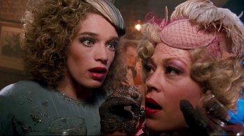 Movie still from “Moonwalker” (1988), directed by Jerry Kramer – Two women are standing next to each other; Close Up shot, Low angle