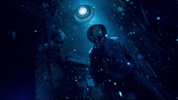 Movie still from “Moonwalker” (1988), directed by Jerry Kramer – A man standing under a light in the snow; Medium shot, Low angle