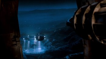 Movie still from “Moonwalker” (1988), directed by Jerry Kramer – An image of an airplane that is flying in the sky at night; Extreme Wide shot, Overhead angle