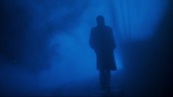 Movie still from “Moonwalker” (1988), directed by Jerry Kramer – A man standing in the middle of the night in the fog; Wide shot, Low angle