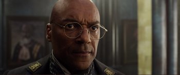 Movie still from “Mortal Engines” (2018), directed by Christian Rivers – An older man wearing glasses looking at the camera; Close Up shot, Low angle