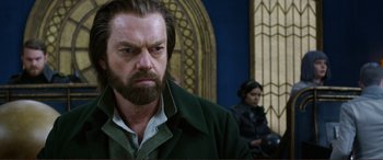 Movie still from “Mortal Engines” (2018), directed by Christian Rivers – A person with a beard wearing a jacket; Close Up shot, Over the shoulder angle
