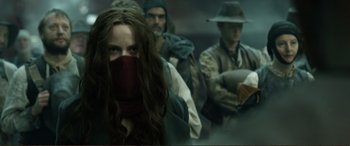 Movie still from “Mortal Engines” (2018), directed by Christian Rivers – A group of people standing in a room; Medium shot, Low angle