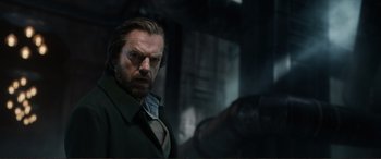 Movie still from “Mortal Engines” (2018), directed by Christian Rivers – A person wearing a suit and tie; Close Up shot, Low angle