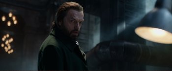 Movie still from “Mortal Engines” (2018), directed by Christian Rivers – A person wearing a green jacket; Close Up shot, Low angle
