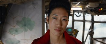 Movie still from “Mortal Engines” (2018), directed by Christian Rivers – A person wearing a red jacket; Close Up shot, Low angle