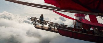 Movie still from “Mortal Engines” (2018), directed by Christian Rivers – A woman standing on a bridge above the clouds; Extreme Wide shot, High angle