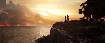 Movie still from “Mortal Engines” (2018), directed by Christian Rivers – Two people are standing on a cliff overlooking the ocean; Extreme Wide shot, Low angle
