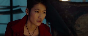 Movie still from “Mortal Engines” (2018), directed by Christian Rivers – A person wearing a red jacket; Close Up shot, Over the shoulder angle