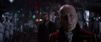 Movie still from “Mortal Engines” (2018), directed by Christian Rivers – A man in a red jacket and a man in a black jacket; Close Up shot, Low angle