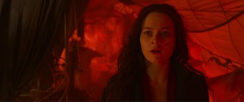 Movie still from “Mortal Engines” (2018), directed by Christian Rivers – A woman in a red room looking at the camera; Close Up shot, Low angle