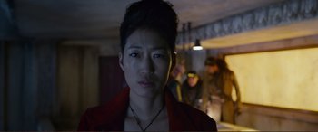 Movie still from “Mortal Engines” (2018), directed by Christian Rivers – A woman in a red jacket is looking at the camera; Close Up shot, Over the shoulder angle